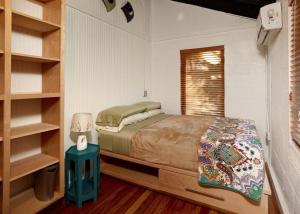 um pequeno quarto com uma cama e uma janela em Folly Vacation 114A Townhouse near the beach, pet friendly em Folly Beach