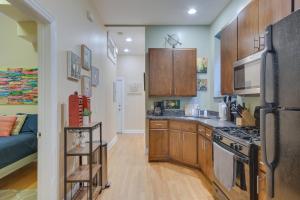 a kitchen with wooden cabinets and a stove at Pet-Friendly Chicago Getaway 4 Mi to Downtown! in Chicago
