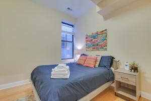 a bedroom with a blue bed and a window at Pet-Friendly Chicago Getaway 4 Mi to Downtown! in Chicago