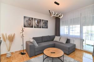 a living room with a couch and a table at Apartman Dina in Pirot