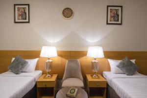 Säng eller sängar i ett rum på Snood Al Maaly Hotel
