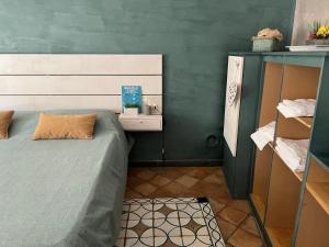 a small bedroom with a bed and a table at Casa Marieta in Sarzana