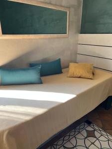 a large bed with two pillows on top of it at Casa Marieta in Sarzana