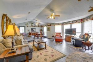 a living room with a couch and a table at Buckhead Cabin with Fireplaces and Private Pool! in Eatonton 