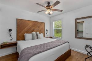 a bedroom with a bed and a ceiling fan at Cozy Cottage • 2 King Beds • Grove • Kayaks • Washer/Dryer in Grove