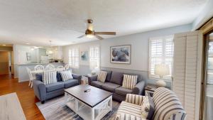 a living room with a couch and a table at True Blue Villas Your 3BR Oasis in Pawleys Island