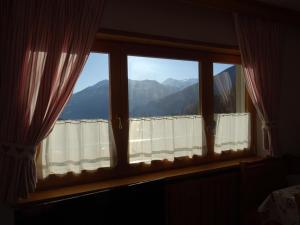 a window with a view of a mountain at CASA VIDI in Madonna di Campiglio