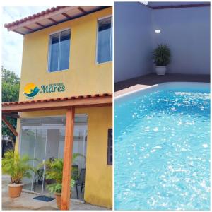 a building and a swimming pool next to a house at Recanto dos Mares - Chalés e suíte - Bertioga-SP-Próximo Sesc in Bertioga