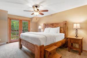 een slaapkamer met een groot bed en een plafondventilator bij Copperwood 5 in Eagle River