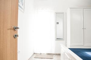 a bathroom with white walls and a door at Apartment Ivan in Drvenik Mali