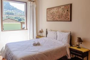 A bed or beds in a room at Chamosa e aconchegante casa em Petrópolis VGL041
