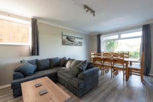a living room with a couch and a table at 5 Bedroom Detached Beach House Poole in Parkstone