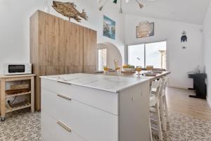 a kitchen with a white island in a room at Charming townhouse with air conditioning in Anglet - Welkeys in Anglet