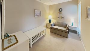 a living room with a couch and a chair at Scenic Golf Villa River Club 2BR Getaway in Pawleys Island