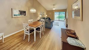 a dining room and living room with a table and chairs at Scenic Golf Villa River Club 2BR Getaway in Pawleys Island