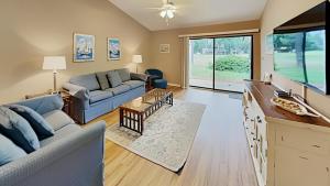 a living room with two couches and a large window at Scenic Golf Villa River Club 2BR Getaway in Pawleys Island