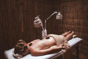 a nude woman laying in a bathtub under a towel at Surf Lodge Punta de Lobos in Pichilemu