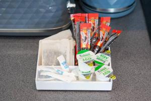 a box filled with toothbrushes and toothpaste at Central Buckingham Apartment #3 with Free Parking, Pool Table, Fast Wifi and Smart TV with Netflix by Yoko Property in Buckingham