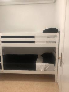 a white bunk bed in a room at Torresal in Torrevieja