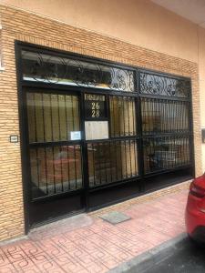 a front door of a building with wrought iron gates at Torresal in Torrevieja