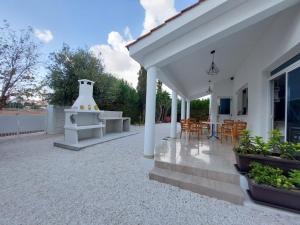 a patio of a house with a table and chairs at Villa Agios Georgios with Private Pool in Peyia