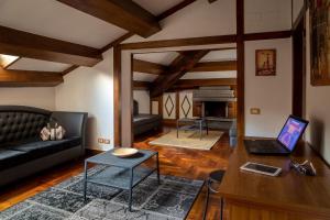 a living room with a couch and a laptop on a table at Suite Artis Barberini in Rome