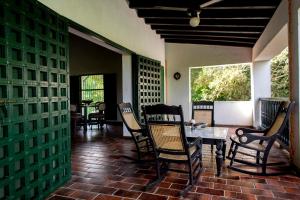 a dining room with chairs and a table on a patio at Sotovocce Casa Campestre in Turbaco