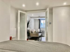 a bedroom with a bed and a living room at Brighton Palms 2 in Brighton & Hove