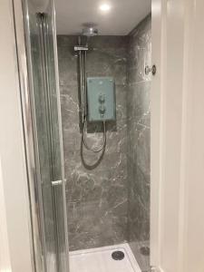 a bathroom with a shower with a glass door at Brighton Palms 2 in Brighton & Hove