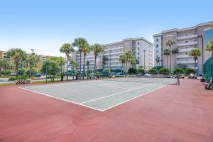 a tennis court in a parking lot with palm trees at Gulf Dunes in Fort Walton Beach
