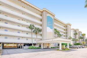 a rendering of the front of a hotel with a parking lot at Gulf Dunes in Fort Walton Beach