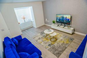 TV a/nebo společenská místnost v ubytování Caasi Homes