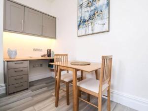 a kitchen with a wooden table and two chairs at The Hideaway - Perfect couples retreat with Free parking on driveway in Lytham St Annes