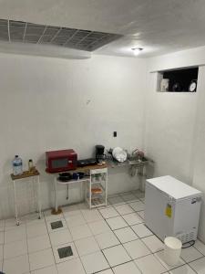a kitchen with white tile floors and a counter top at Azul y buenas noches in Orizaba