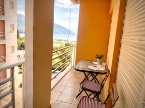 a balcony with a table and chairs and a view of the ocean at L'odore del mare in Vlorë
