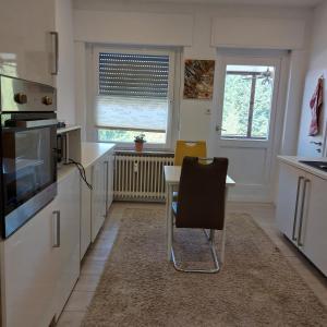 a kitchen with a table and a chair in it at Ferienwohnung Stella Herford in Herford