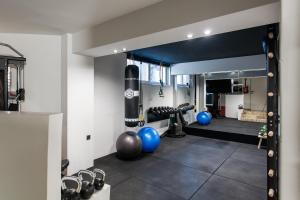 a boxing gym with a punching bag and blue balls at Sol Residence - Private Pool Gym Glyfada in Athens