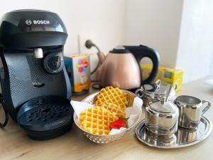 a kitchen counter with a waffle fries and a coffee maker at Panoramic Sea view - Balcony - Tramway - 2 Bedrooms - Wifi - Fully equipped kitchen in Nice