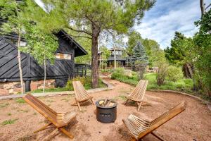 a yard with two chairs and a trash can at Pet Friendly Flagstaff Studio Cabin with Patio in Flagstaff