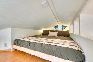 a large bed in a small room in a attic at Pet Friendly Flagstaff Studio Cabin with Patio in Flagstaff