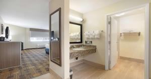 a hotel room with a bathroom with a sink and a mirror at Best Western Amador Inn in Jackson +69 photos