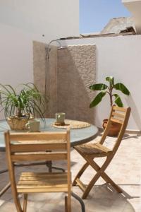 a table and a chair and a table with plants at La Casita del Sol in Soo