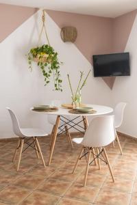 a dining room with a white table and chairs at La Casita del Sol in Soo