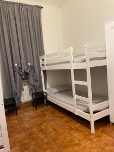 a bedroom with two bunk beds with a ladder at Appartamento vicino centro in Turin