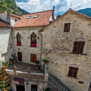 an old stone house with a red roof at Guest House Forza Lux in Kotor