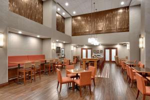 a dining room with tables and chairs in a room at Hampton Inn & Suites Pocatello in Pocatello