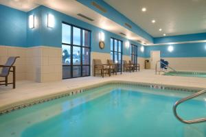 a swimming pool in a room with blue walls at Hampton Inn & Suites Pocatello in Pocatello