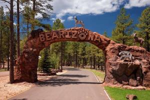 an entrance to a park with a stone arch with animals on it at DoubleTree by Hilton Hotel Flagstaff in Flagstaff