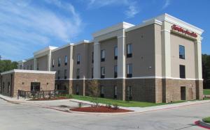 a large building with a sign on the side of it at Hampton Inn and Suites Hope in Hope