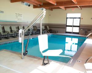 a swimming pool with a chair in front of it at Hampton Inn and Suites Hope in Hope